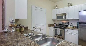 Kitchen with double sink and granite countertops